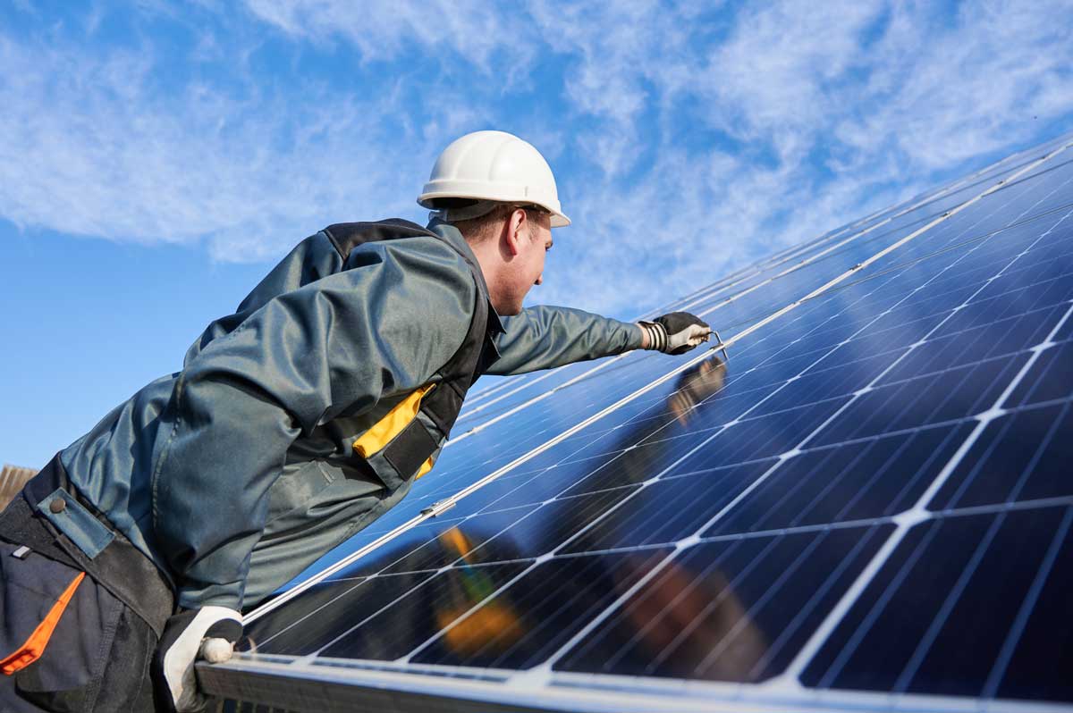 Worker installing a solar panel